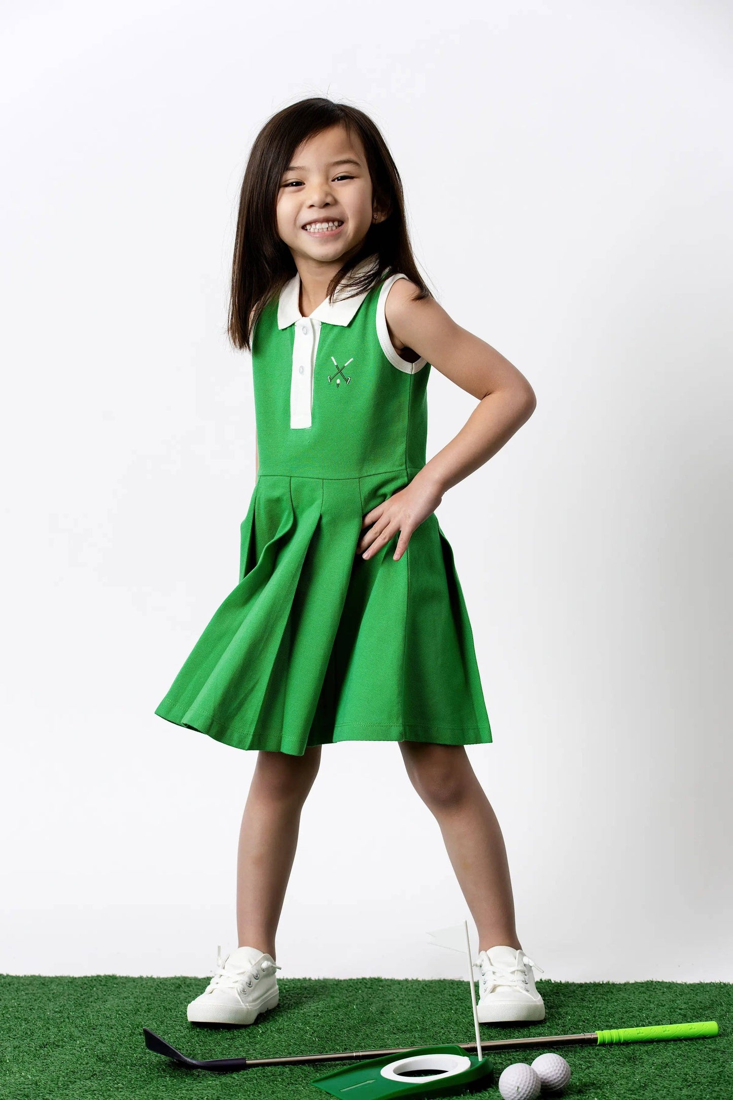 Golf Clubs on Green Pleated Tennis Dress