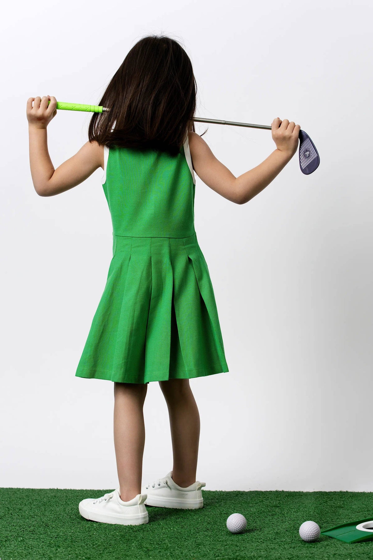 Golf Clubs on Green Pleated Tennis Dress