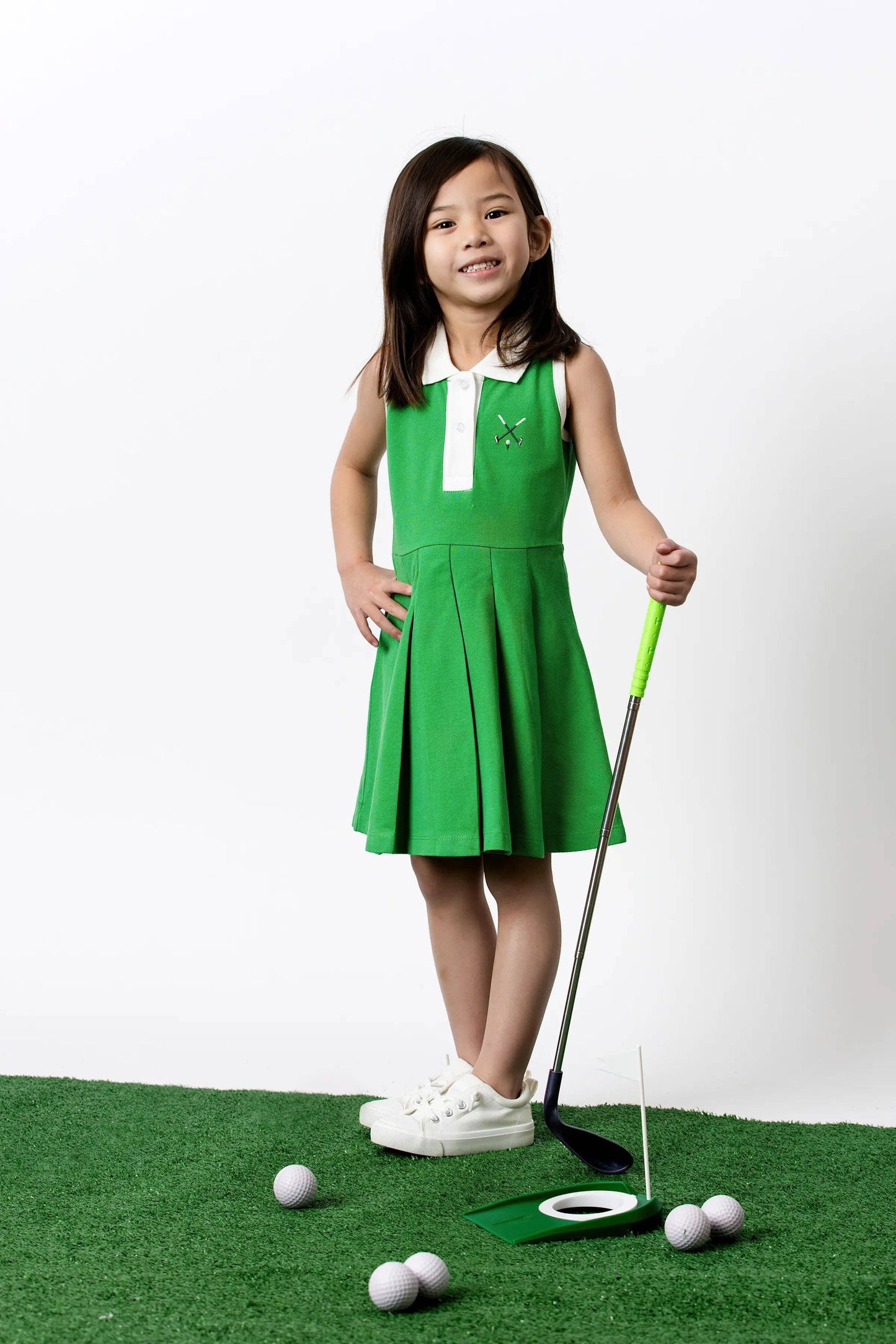 Golf Clubs on Green Pleated Tennis Dress